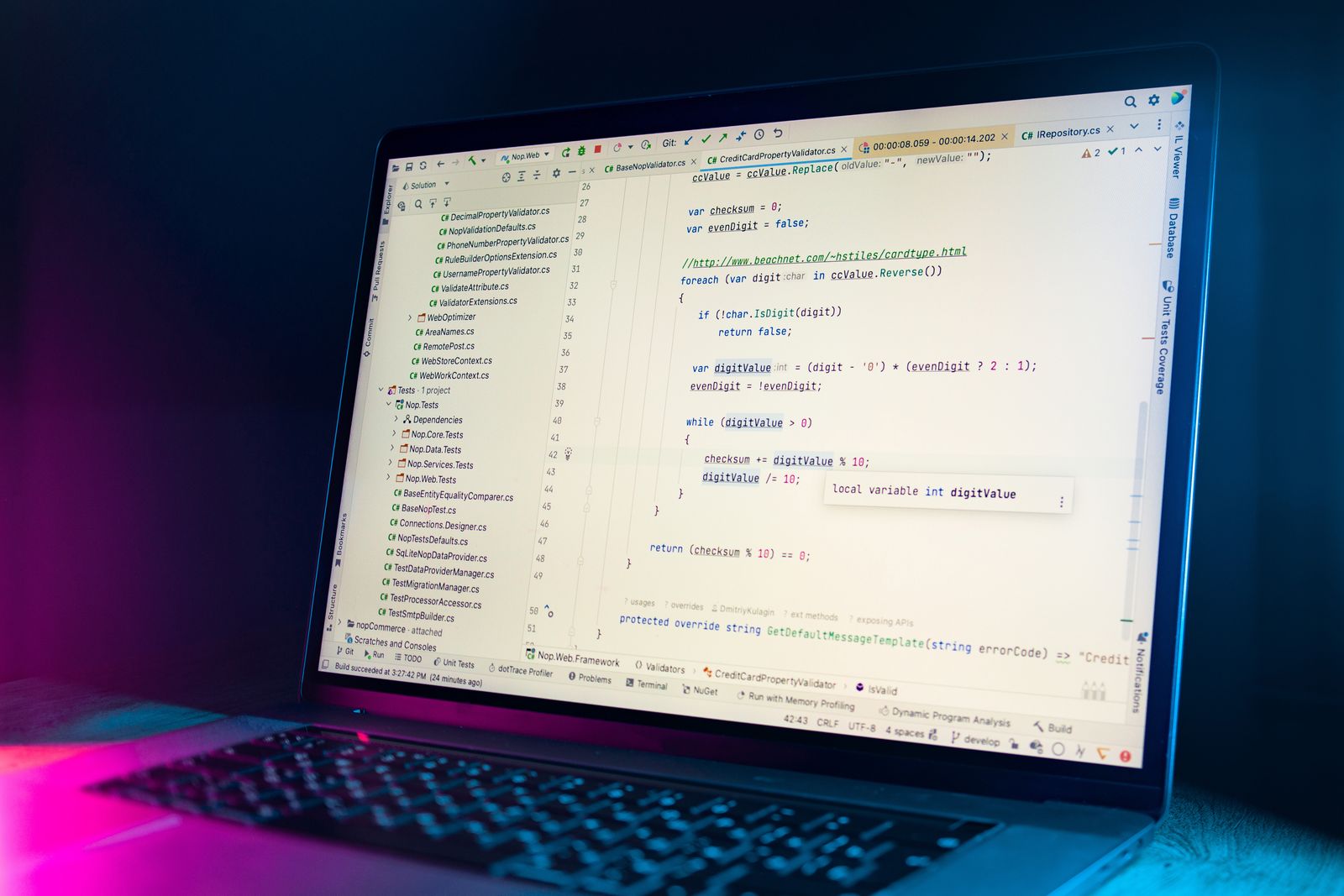 Laptop showing code in a dark studio